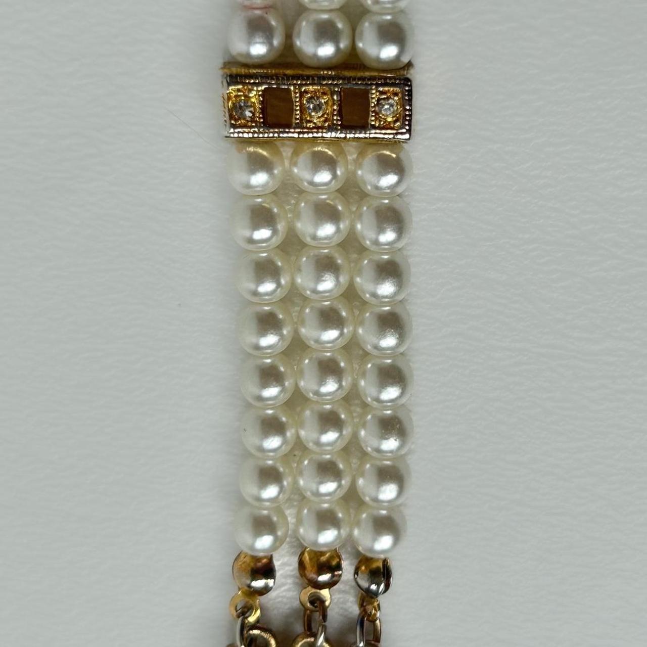 Faux pearl and golden bracelet with rhinestones